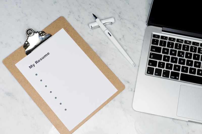 AI resume writing tools displayed on laptop screen showing job interview success